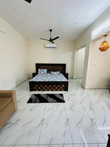 a bedroom with a bed in a room with marble floors at Forest breeze villa in Jalandhar