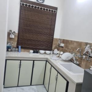 a bathroom with a sink and a shower curtain at Forest breeze villa in Jalandhar +19 photos