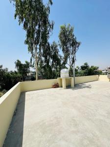 a large patio with a table on a wall at Forest breeze villa in Jalandhar
