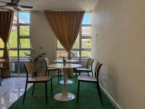 a dining room with tables and chairs and a window at Apex Hotel by Setapak Central in Kuala Lumpur