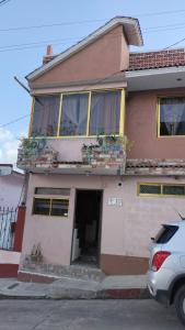 a house with a car parked in front of it at HabitacionSUPER4 2 personas Casa SFco in Zacatlán