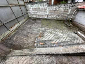 an outside view of a building with a brick floor at Céntrico con cocina parqueadero e internet in Baños
