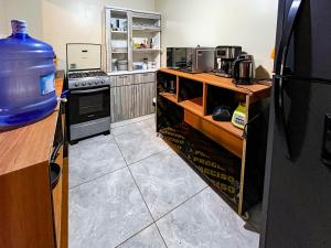 a kitchen with a bottle of water on a counter at Hospedaje Josué Paracas in Paracas +78 photos