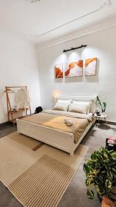 a bedroom with a large bed in a white room at BeHomestay in Hai Phong