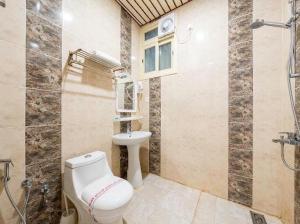 a bathroom with a toilet and a sink at فندق مشارف ابها in Abha +21 photos