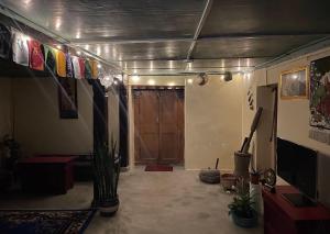 a room with a hallway with a door and some plants at Pakha Dhim Heritage Homestay in Namchi