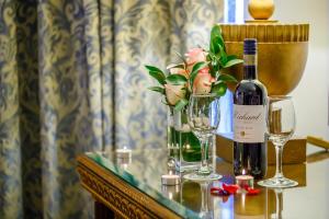 a bottle of wine and two glasses on a table at Grand Excelsior Hotel - Bur Dubai in Dubai