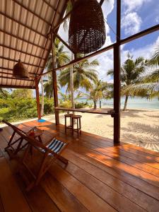 a porch of a resort with a view of the beach at Ombak Biru Resort in Tua Pejat