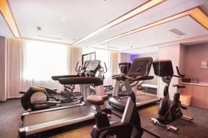 a gym with several exercise bikes in a room at 库尔勒孔雀河景观带滨河西路亚朵酒店 in Korla