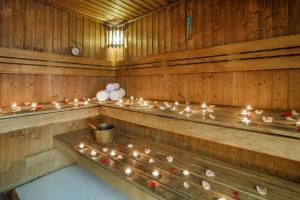 a row of wooden benches in a sauna with candles at Grand Excelsior Hotel - Bur Dubai in Dubai