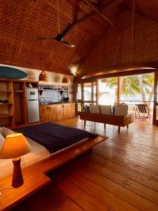 a bedroom with a bed and a table in a room at Ombak Biru Resort in Tua Pejat