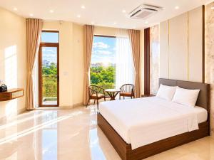 a bedroom with a bed and a table at O Lily Hotel in Ninh Binh
