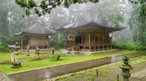 a small building with a roof in the rain at ゲストハウスわたうさぎ in Tsuruoka
