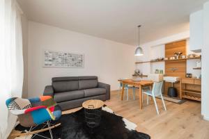 a living room with a couch and a table at M-Loft merangardenvilla in Merano