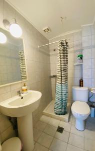 a bathroom with a sink and a toilet at Island Traditional House in Poros +15 photos