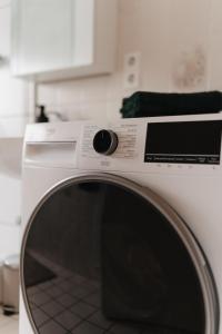 a white washing machine sitting in a kitchen at Bright Nest in Drensteinfurt +45 photos