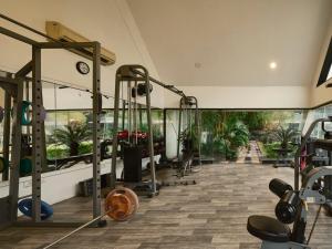 a gym with treadmills and weights in a building at RB Villa in Indore