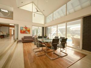 a living room with a glass table and chairs at RB Villa in Indore