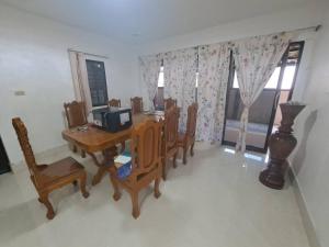 a dining room with a wooden table and chairs at Pani House Hatyai 6 in Hat Yai