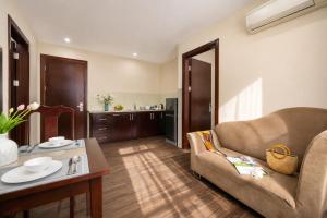 a living room with a couch and a table at Sea Front Apartment & Spa Da Nang in Danang +94 photos
