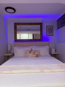 a bedroom with a bed with a purple light at Intercon Ground in Queens