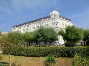a large white building with trees in front of it at Apartment Golf Beach Régina Biarritz in Biarritz