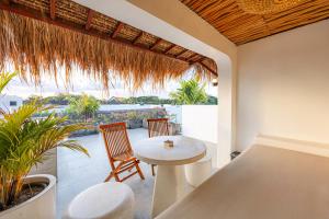 a dining room with a table and chairs on a patio at Anatha Villa Uluwatu in Badung