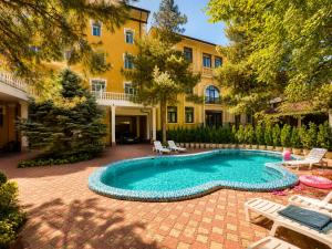 a swimming pool in front of a building at Retro Palace Residence Tashkent in Toshkent-Passajir Bekati