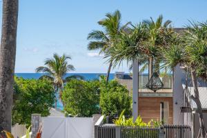a view of the ocean from a house with palm trees at 3WR Sunshine Beach Dream 3BR in Sunshine Beach