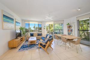 a living room with a couch and a table at 3WR Sunshine Beach Dream 3BR in Sunshine Beach