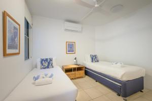 a bedroom with two beds and a night stand at 3WR Sunshine Beach Dream 3BR in Sunshine Beach