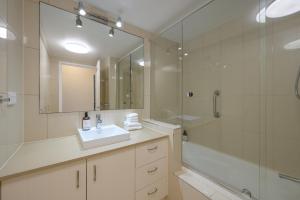 a bathroom with a sink and a shower and a mirror at 3WR Sunshine Beach Dream 3BR in Sunshine Beach +6 photos