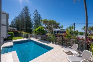 a swimming pool with two chairs and a fence at 3WR Sunshine Beach Dream 3BR in Sunshine Beach