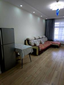 a living room with a couch and a table at Arga bilig complex in Ulaanbaatar