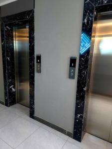 a row of elevators in a building with mirrors at Arga bilig complex in Ulaanbaatar