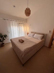 a bedroom with a bed with a towel on it at Apartment Las 2 in Fanari +10 photos