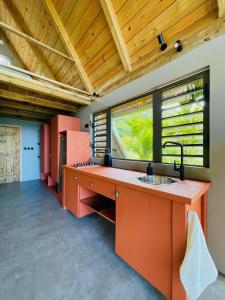 an open kitchen with orange cabinets and a sink at The A Lodge in Grand Sable