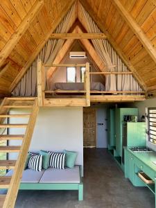 a loft bed in a tiny house at The A Lodge in Grand Sable