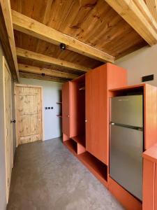 a kitchen with orange cabinets and a refrigerator at The A Lodge in Grand Sable +33 photos