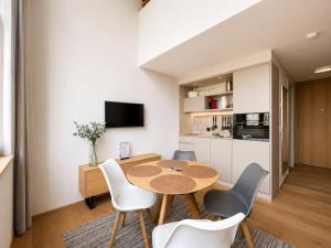 a kitchen and dining room with a table and chairs at LAKE-SIDE Fernblick in Romanshorn