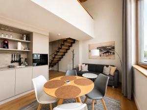 a dining room and living room with a table and chairs at LAKE-SIDE Fernblick in Romanshorn