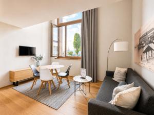 a living room with a couch and a table at LAKE-SIDE Säntisblick in Romanshorn