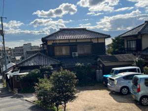a house with cars parked in front of it at 安易旅館二楼 in Okayama +6 photos