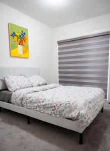 a bedroom with a bed in a room with a shutter at Hiltons Villa in Brampton