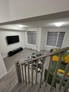 a living room with a couch and a television at Hiltons Villa in Brampton