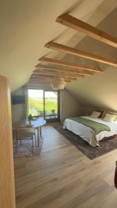 a bedroom with a bed and a table at B&B Les Trois Pignons in Diksmuide