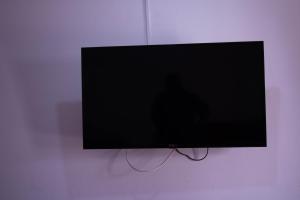 a flat screen tv hanging on a wall at TIlcara Rooms in Tilcara