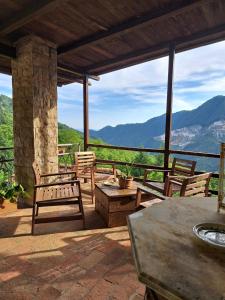 a patio with chairs and a table with a view at La Panciotta in Azzano
