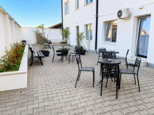 a patio with tables and chairs on a building at DD Apartments - Iuliu Moldovan in Cluj-Napoca
