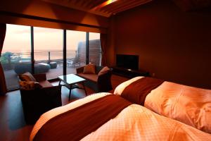 a hotel room with two beds and a balcony at ゆうみ in Kyonan +26 photos